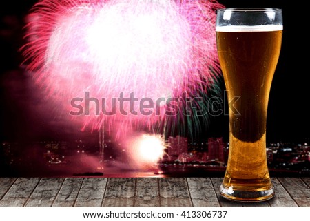 A Glass of beer on  wooden background fireworks.Concept Festive Celebrations.
