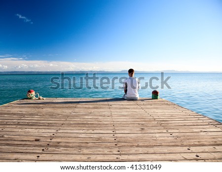 young man relax siting on pier Royalty-Free Stock Photo #41331049