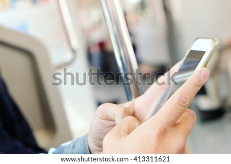 Close up image of businessman text messaging on his phone in subway,Social media life