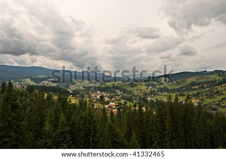 green mountain farmland with stormy clouds. Carpathian mountain, Ukraine
