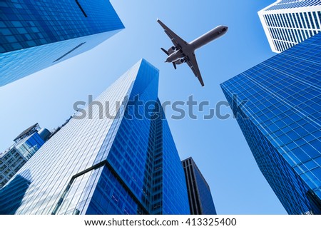 airplane over office buildings of new york