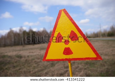 Sign of radioactive danger in front of "red forest" in the Chernobyl Nuclear Power Plant within the Exclusion Zone.