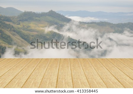 Top view wooden table and mountain blurred background.This photo for show product.