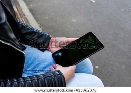 Female hands with tablet. Top view.