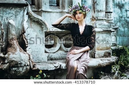 beautiful girl with make-up and hairstyle on background of ancient architecture