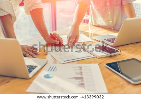 Business people analyzing investment charts. Accounting , with soft focus, vintage tone Royalty-Free Stock Photo #413399032