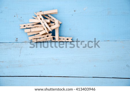 wooden clothespins and blue wooden background