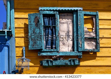green venetian blind and a yellow wall  in la boca buenos aires argentina

