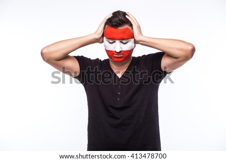 Unhappy and Failure of goal or lose game emotions of  Austrian football fan in game supporting of Austria national team on white background. European football fans concept.