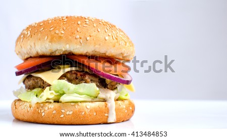 Burger full face with vegetables, spices and fries. Meat hamburger. Hamburger with knife. Beef hamburger. Organic hamburger