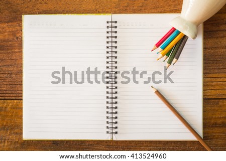 top view of notebook paper and pencil on office wooden table and copy space for your text,education concept