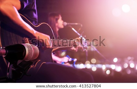 Guitarist on stage for background, soft and blur concept Royalty-Free Stock Photo #413527804