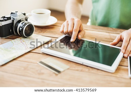 Young man planning vacation trip with digital tablet