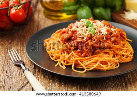 Delicious spaghetti served on a black plate Royalty-Free Stock Photo #413580649