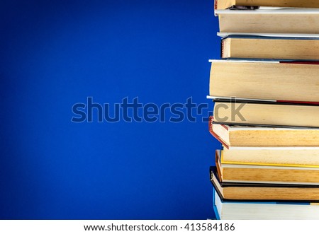 A pile of old books on a colored background