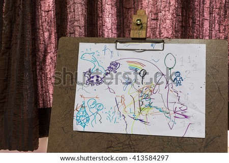 Child's drawings on sketch board