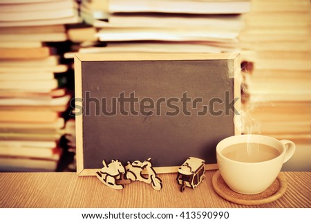 milk coffee and blackboard with blur stacking book background