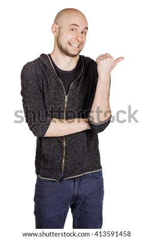 Portrait bald young man shows something his finger. human emotion expression and lifestyle concept. image on a white studio background.