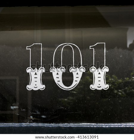 House number one hundred and one on a glass window