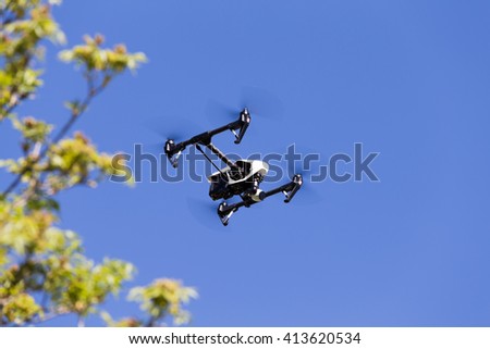 Drone with 4K resolution flying on blue sky