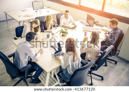 Meeting of young business people in a modern office - Start up company, workers brainstorming Royalty-Free Stock Photo #413677120