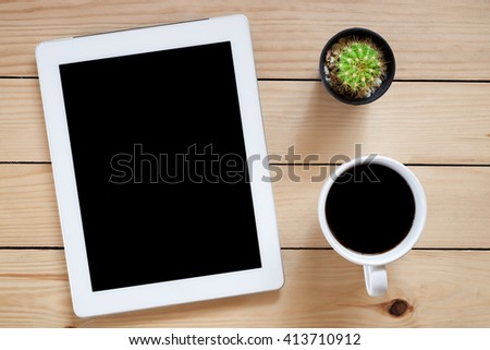 Office workplace with blank screen tablet and coffee cup on rustic wood table.Top view.Flat lay images.Office workplace concept.Office supplies and gadgets on office workplace.