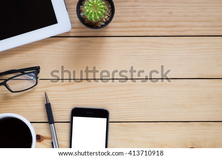 Office workplace with blank screen tablet, smart phone, pen and coffee cup on rustic wood table.Top view with copy space.supplies and gadgets on workspace.Working desk table concept.Flat lay images.