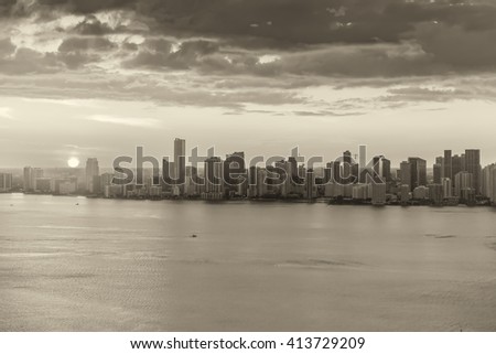 Black and white helicopter view of Miami Beach at sunset.