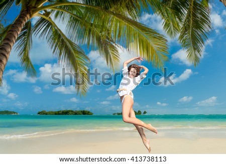 Woman jumping on the tropical beach