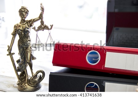 Law concept, statue, laptop and folder on wood table