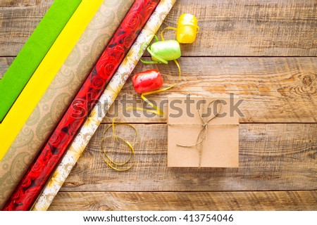Colored gift boxes on wooden background with ribbon