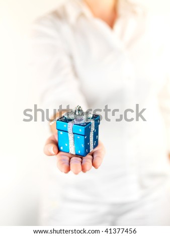 Christmas ornaments presented by hand isolated against a white background