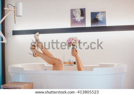 Bride hiding in the bath Royalty-Free Stock Photo #413805523