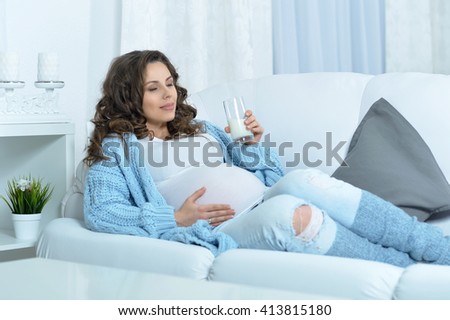 pregnant woman with  glass of milk
