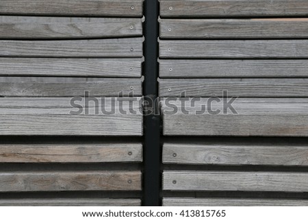 Modern  shaped gray wooden bench outdoor furniture detail as background image