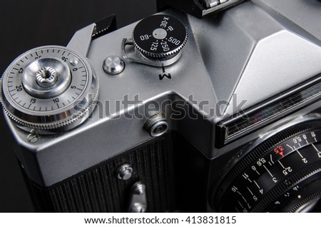 Vintage camera close up.black background. Shutter speed dial.