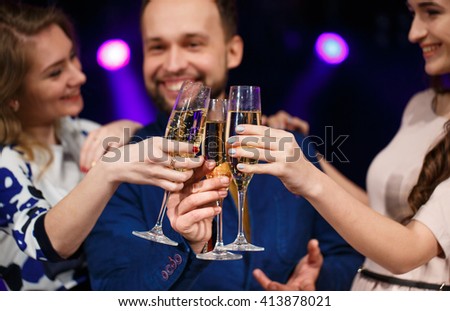 Party, holidays, celebration, nightlife and people concept - smiling friends with glasses of champagne in club