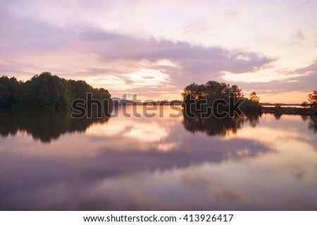 Sunset scene with reflection at mangrove lake in Sabah Malaysian Borneo. 