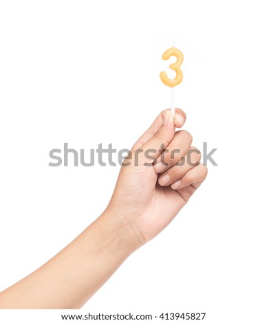 hand holding candle number three birthday isolated on white background
