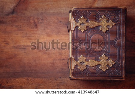 top view of antique book cover, with brass clasps. vintage filtered and toned

 Royalty-Free Stock Photo #413948647