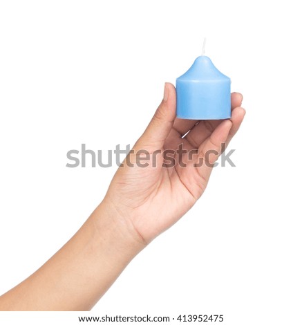 hand holding blue candle isolated on white background