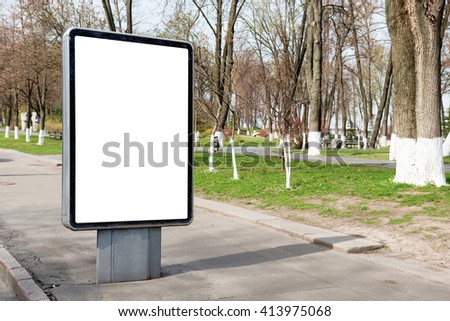 Empty billboard or lightbox on green city street with white isolated background