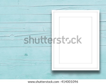 Close-up of one blank picture frame on aqua wooden background