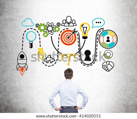 Start up concept with businessman facing concrete wall with sketch Royalty-Free Stock Photo #414020551