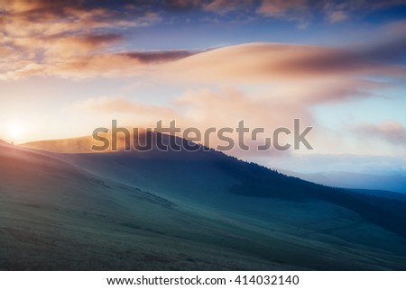Magical hills glowing by sunlight at twilight. Dramatic scene and picturesque picture. Location place Carpathian, Ukraine, Europe. Beauty world. Soft filter, vintage style. Instagram toning effect.