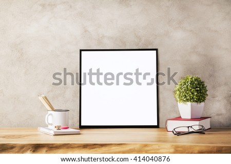 Closeup of wooden table with blank frame, flowerpot, iron mug with pencils and glasses on concrete background. Mock up