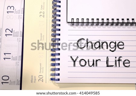 Change your life text concept write on notebook
