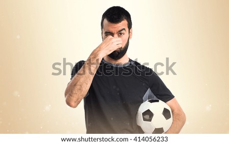 Football player making smelling bad gesture