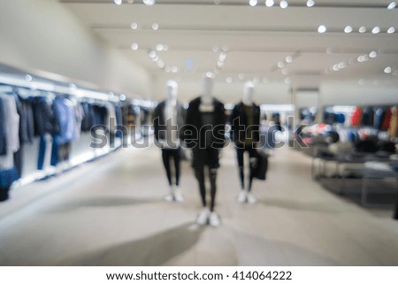 Blur image of jeans display in the fashion store,luxury and fashionable brand,blur background of Jeans shirts at shelf, with bokeh for use as Background,vintage retro color,copy space ,vintage color