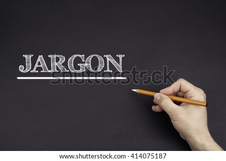 Hand with a white pencil writing: JARGON 
